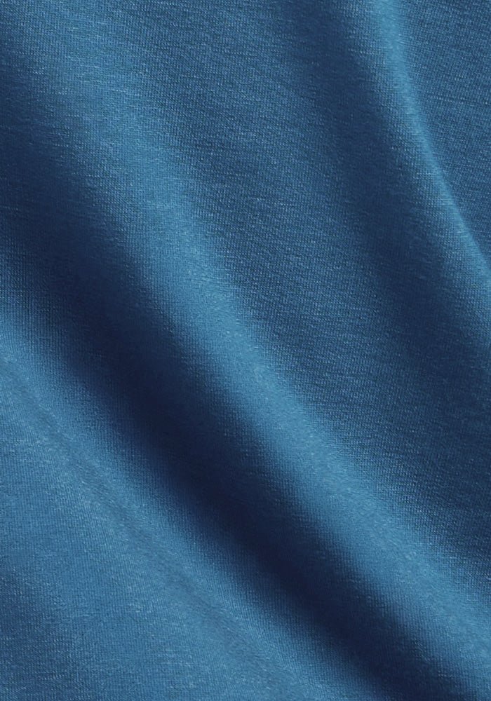 Blue Ashes Jackson Henley by Woolx features soft, smooth blue fabric with gentle drape, folds, and subtle shadows.