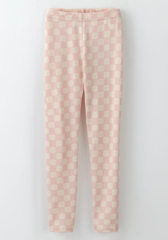 The Woolx Kids Explorer Base Layer Bottoms - Hopscotch Pink are slim-fit leggings with a light pink and cream checkered pattern, elastic waistband, and subtle squares, shown flat on a white background.