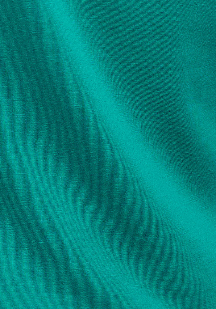 Close-up of Woolx Remi Long Sleeve T-Shirt - Cabana Crush, soft Merino fabric with gentle diagonal shadows.