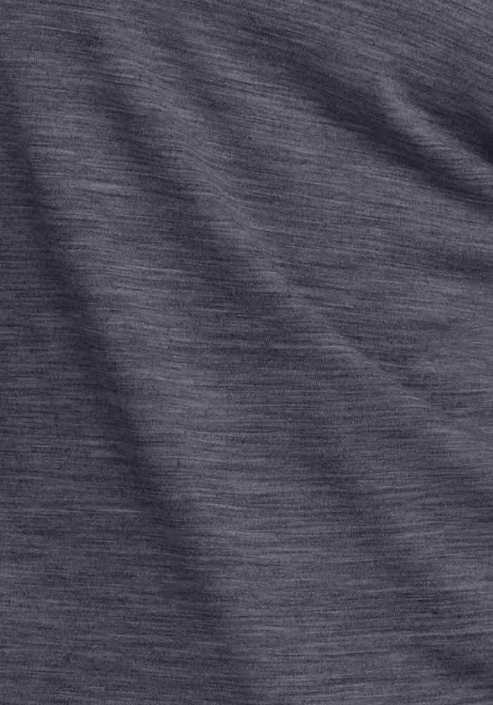 A close-up of the Woolx Junie V Neck in Cinder Melange highlights its soft Merino wool, heathered gray hue, subtle horizontal lines, gentle folds, and moisture-wicking texture with delicate shadows.