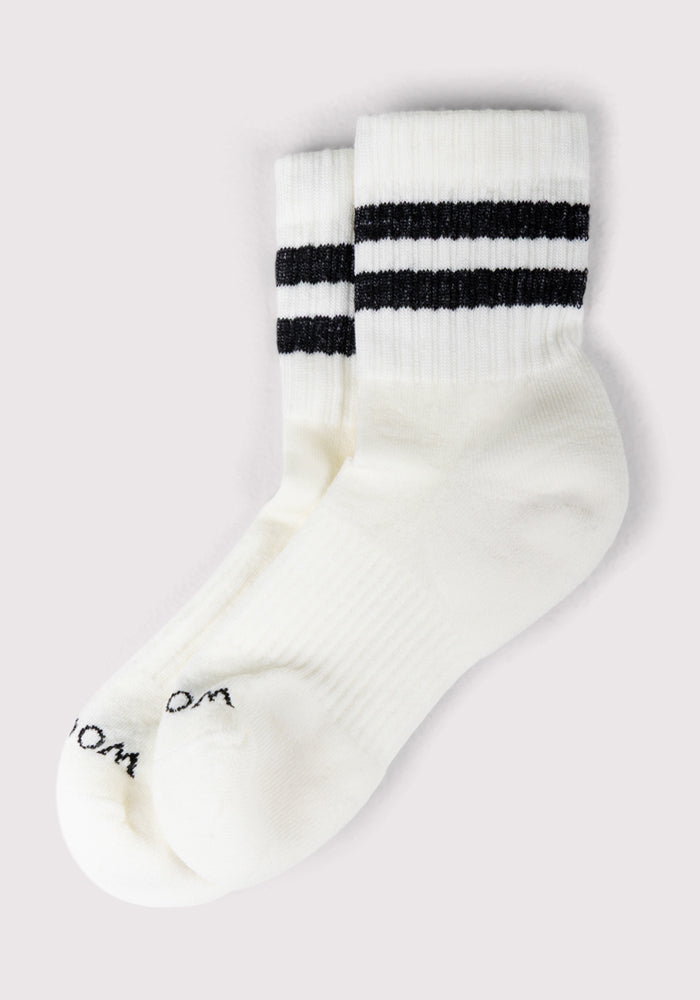 The Woolx Womens Varsity Mini Crew Socks - Classic Stripe are white with two black stripes near the top and faint black text at the toe, shown overlapping on a light background.