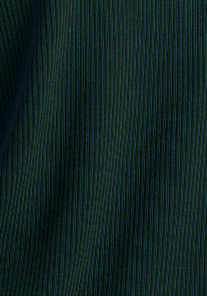 Close-up of Woolx Hadley Ribbed Crew in Deep Pine, showing vertical textured lines and soft folds in the fabric.