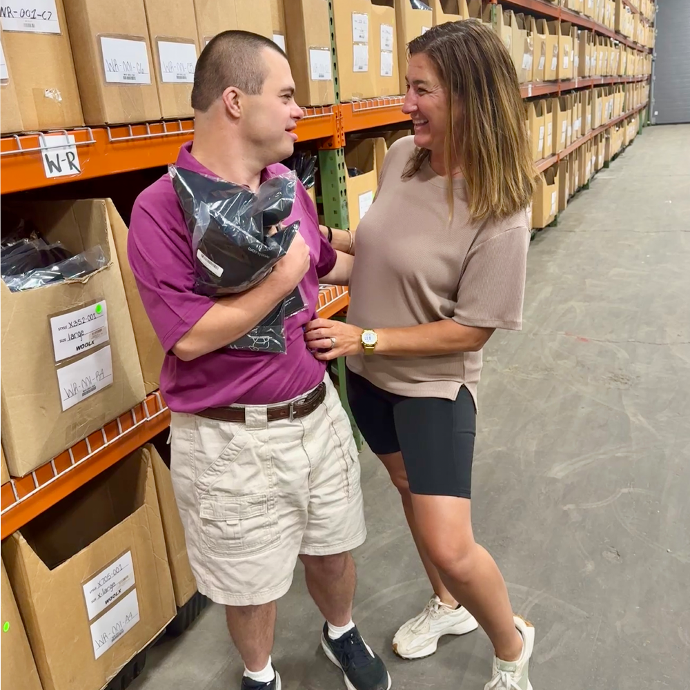 Dom and Nicole in warehouse smiling