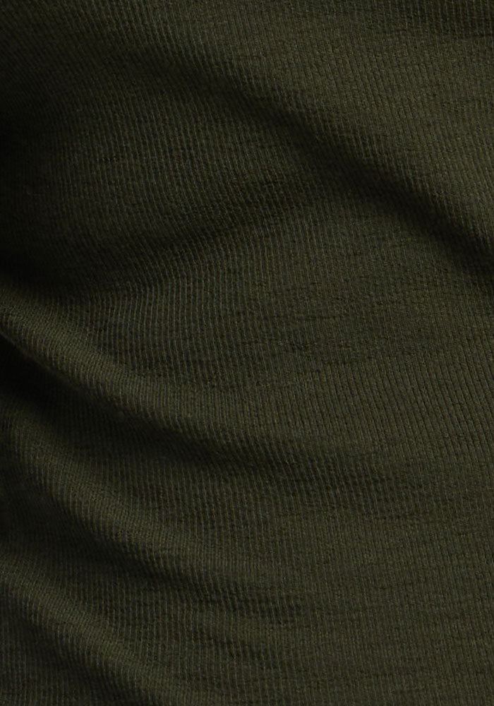 Close-up of Katie Ribbed Long Sleeve by Woolx in Duffel Bag, showcasing merino texture and subtle shadows.