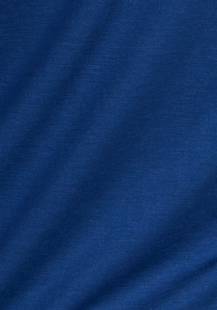 A close-up view of the smooth, soft Estate Blue Merino wool fabric on the Woolx Liza Crew Neck Tee, featuring subtle diagonal folds.