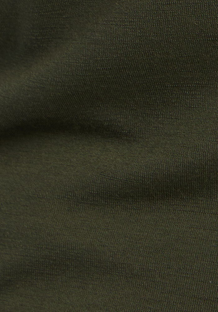 Close-up of Madden Petite Joggers - Everleaf by Woolx: dark green textured fabric, perfect for comfort and style.