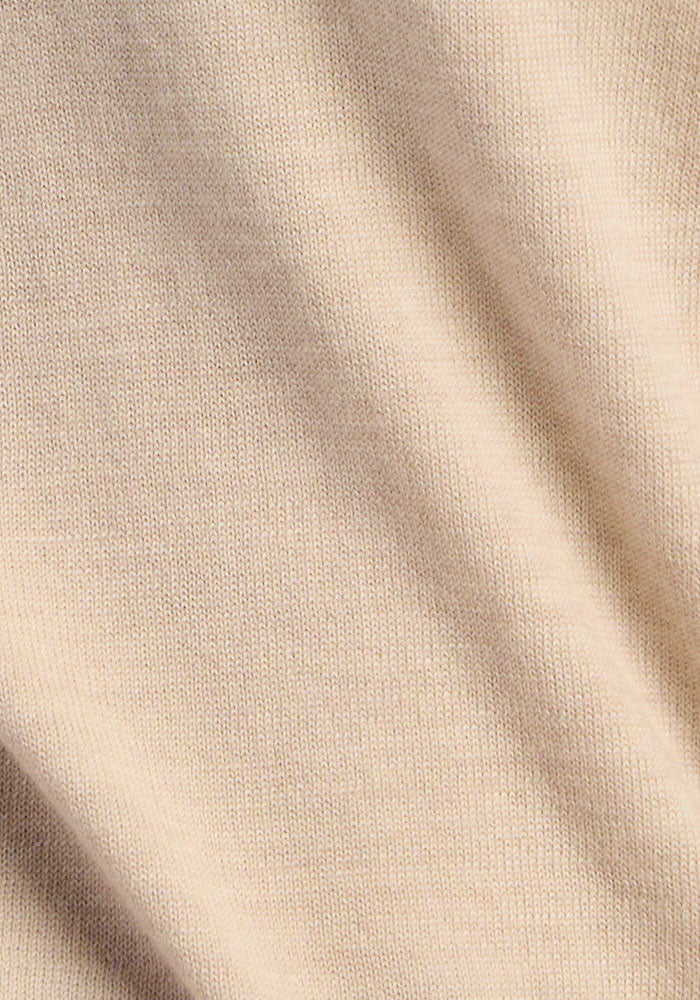 Close-up of Woolx Collins Half Zip Sweater - French Oak, showing soft beige merino wool folds and textured surface.