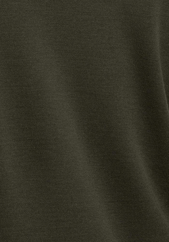 Close-up of Woolx Glacier Long Sleeve Crew in Duffel Bag, highlighting its soft merino fabric and wavy texture.