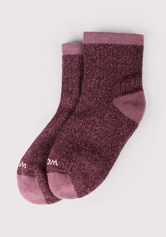 The Woolx Womens Cozy Mini Crew Sock in Grape Harvest features a heathered maroon color with solid mauve heels, toes, and cuffs, shown on a light gray background.