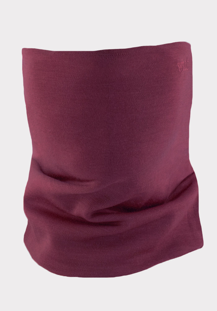 The Woolx Neck Gaiter - Grape Harvest, a maroon cylindrical Merino wool accessory, stands upright on a plain light gray background.