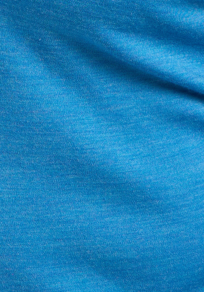 Close-up of Woolx Hannah Long Sleeve Top - Blue Razz, showing soft Merino wool texture, wicking threads, and shading.