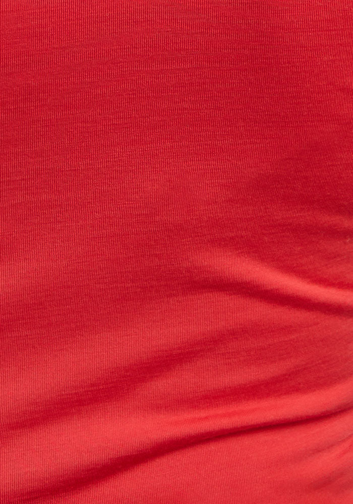 Close-up of Woolx Maggie Bodysuit - Hibiscus fabric showing texture and slight wrinkles.