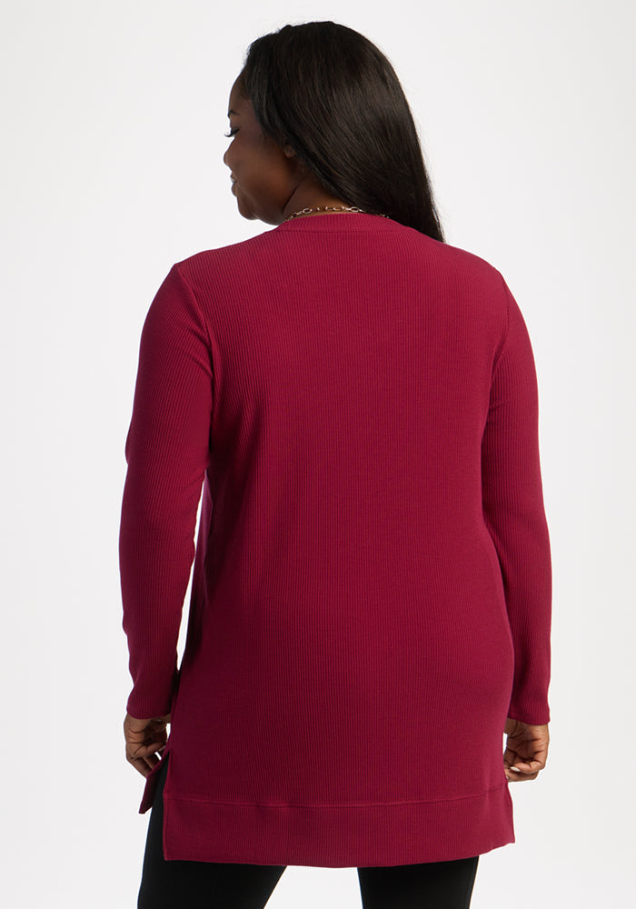 Woman wears Woolx Evie Ribbed Tunic in Beet Red, shown from the back against a plain white background.