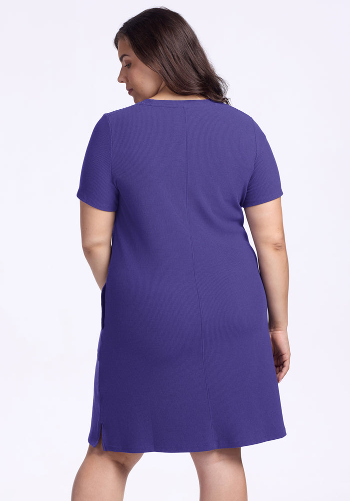 Woman with long brown hair wearing the Woolx Harlowe Ribbed Dress in Berry Indigo, seen from the back.