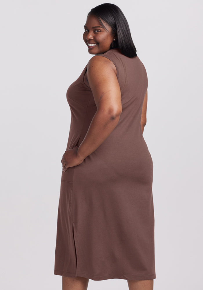 Woman in the Woolx Cassie Dress - Peppercorn stands sideways, smiling with her hand on her hip.