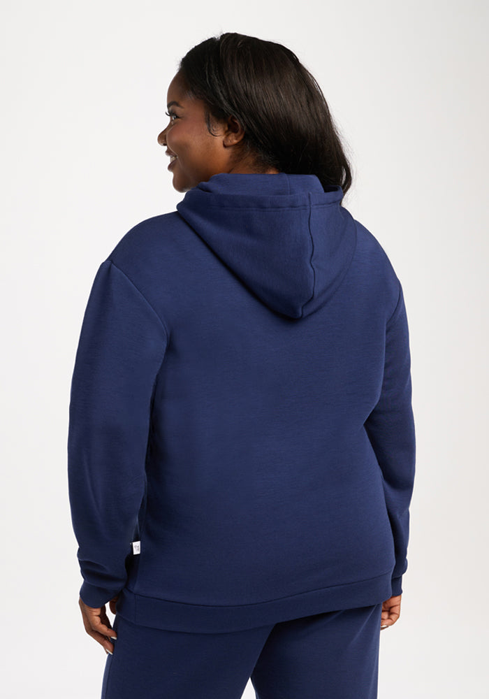 Person in Woolx Avery Hoodie - Ocean Cavern, shown from the back against a plain white background.