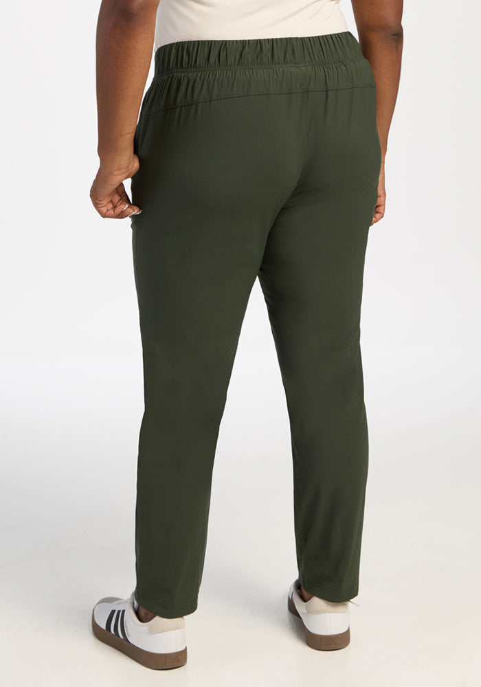 Model in Woolx Nicole Ankle Pants - Duffel Bag, shown from the back with white sneakers on a plain white background.