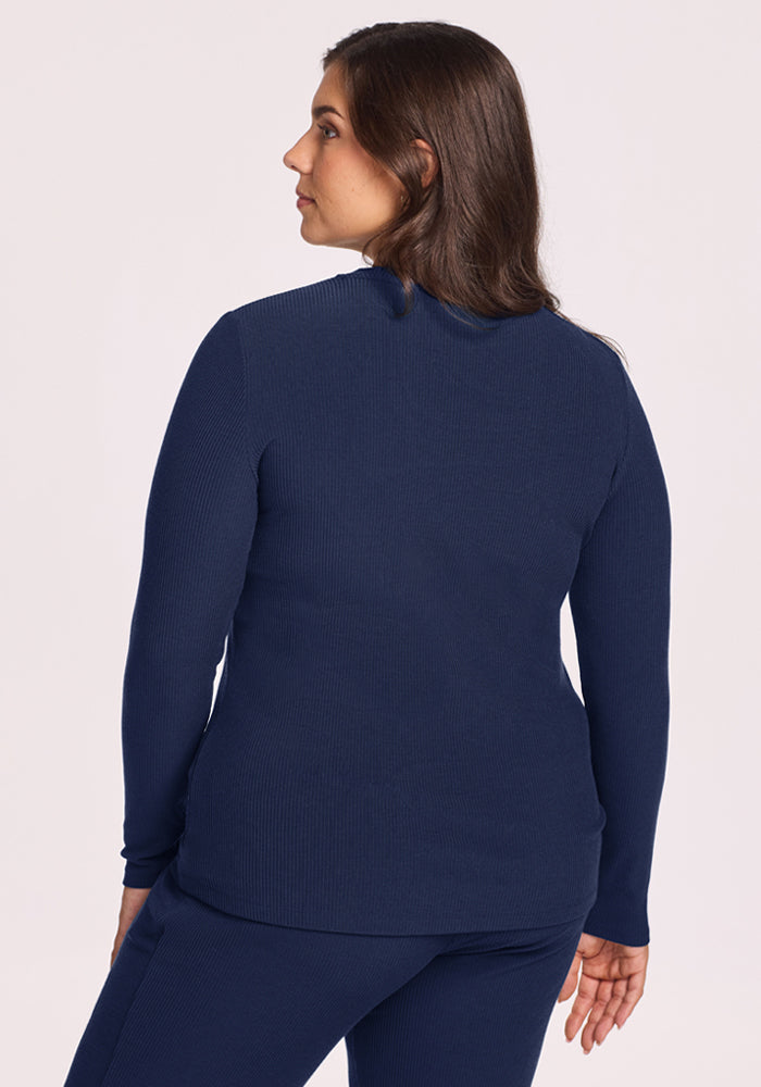Woman with long brown hair wears Woolx Hadley Ribbed Crew in Ocean Cavern, seen from the back.