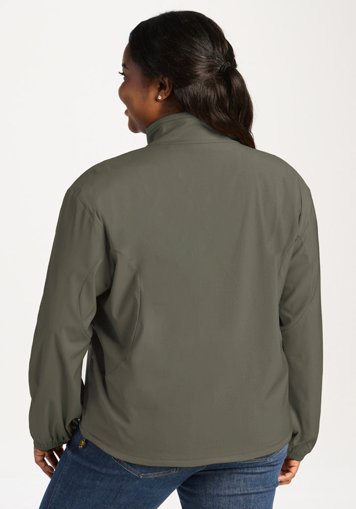 Back view of a person wearing a sage olive Cooper Windbreaker, a long-sleeve jacket with a high collar.