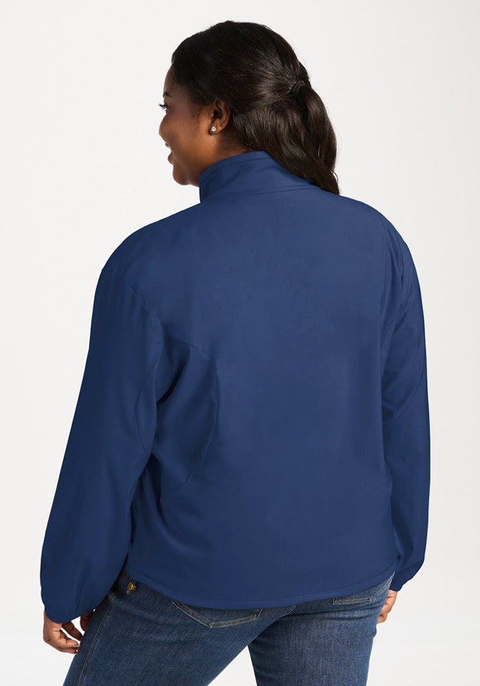 A woman seen from the back wearing a solid Vintage Indigo Cooper Windbreaker.