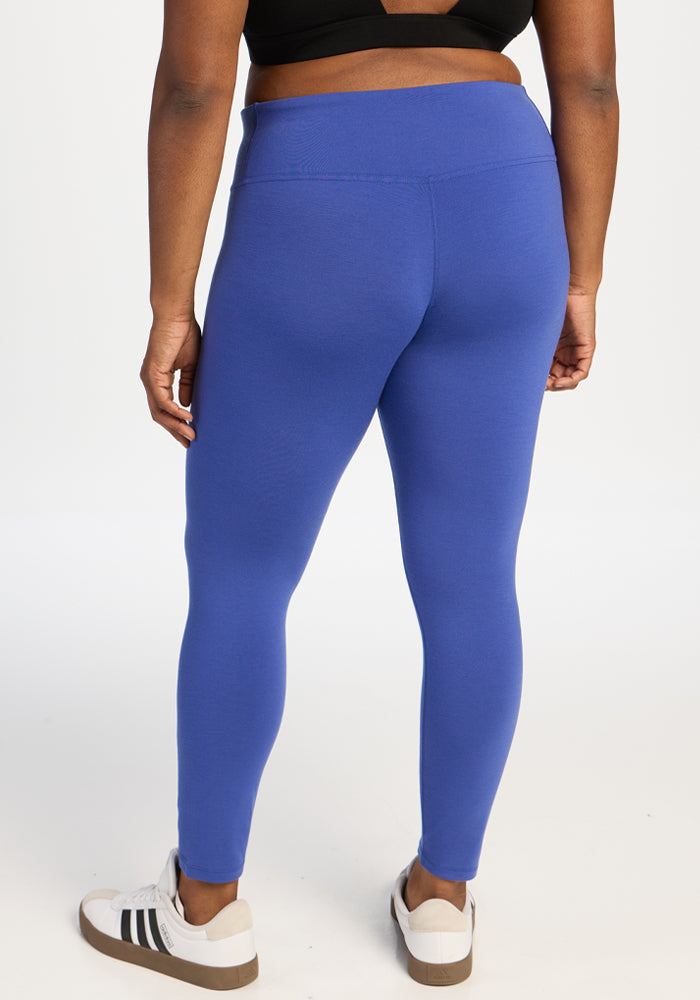 Back view of a person wearing royal blue Angela Leggings and white sneakers.