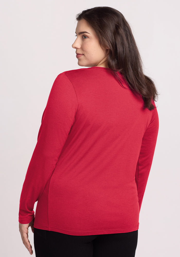 A woman with long brown hair wears the Woolx Millie Long Sleeve in Berry Ice Pop, shown from the back.