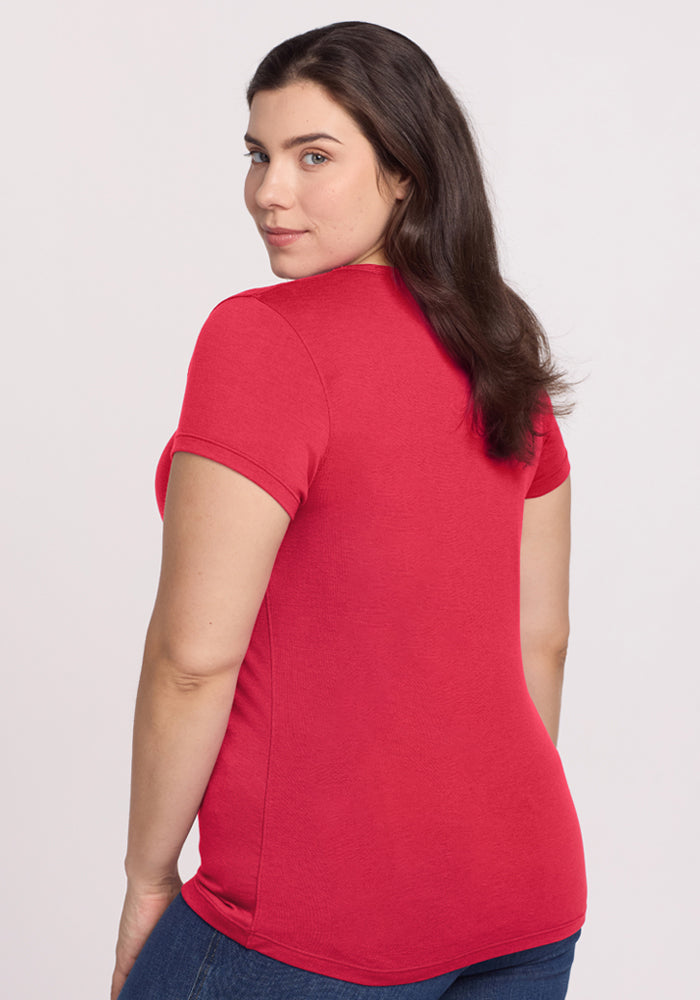 Woman with long brown hair wears the Woolx Addie Crew Neck - Berry Ice Pop, paired with jeans, against a plain background.