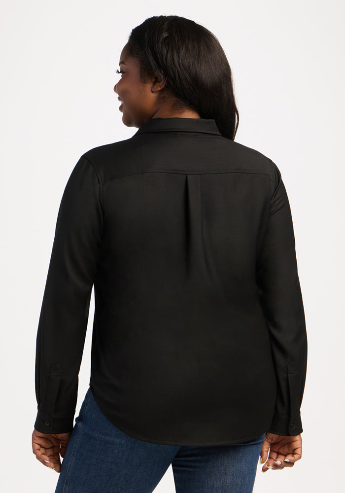 Woman in Woolx Lorelai Button Up - Black, long sleeves, blue jeans, shown from back, smiling left.