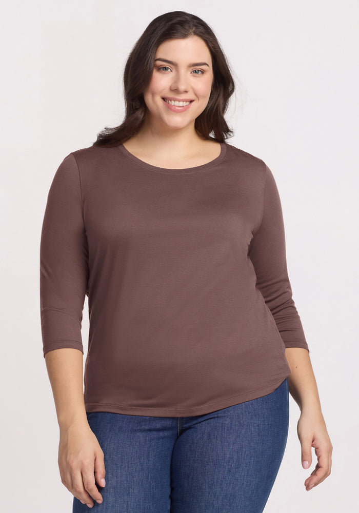 Woman smiling, wearing the Woolx Jenny 3/4 Sleeve Crew Neck in Peppercorn and blue jeans, against a light background. 