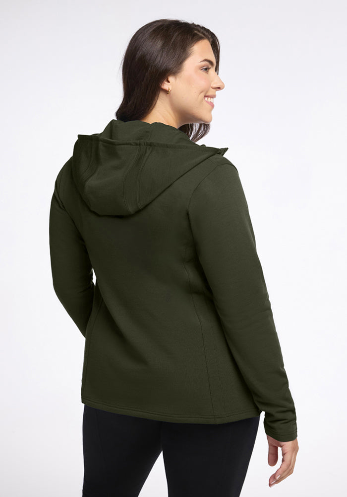 Woman in Woolx Zoey Zip Up Hoodie - Duffel Bag, facing away and smiling, wearing black pants in cold weather.