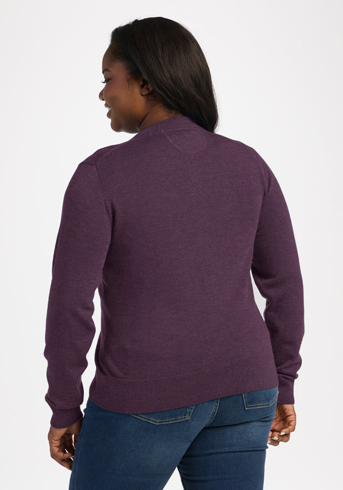 Model wears the Woolx Caitlin Sweater in Purple Iris with blue jeans, back to camera on a white background.