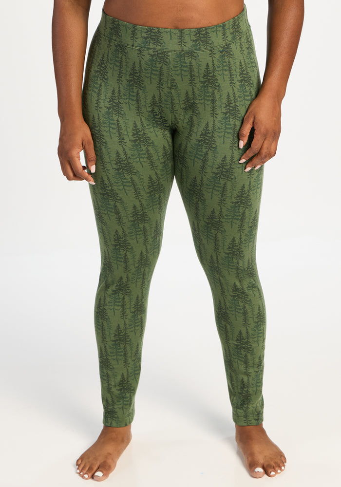 Person in Woolx Taylor Baselayer Leggings - Forest Friends, barefoot, standing against a white background. 