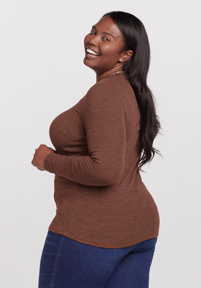 Woman in a Woolx Reese Ribbed Henley - Sable Heather and blue jeans smiles while looking over her shoulder.