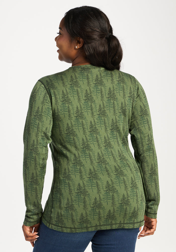 Woman in Woolx Maddie Baselayer Top—Forest Friends, seen from the back, smiling and looking left.