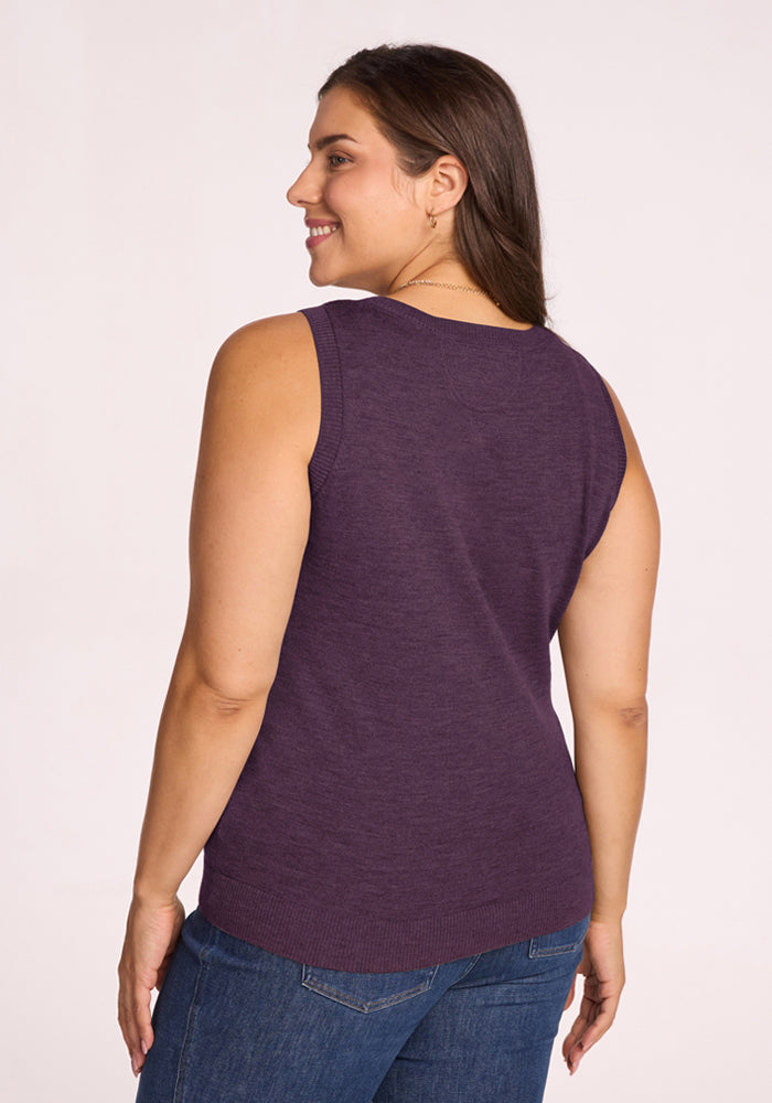 Woman smiling, shown from the back in Woolx Chessy Tank Top - Purple Iris and blue jeans against a plain background.