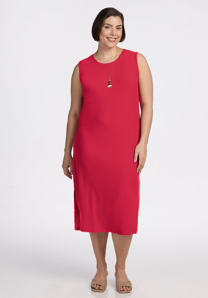 Woman wearing the Woolx Iris Ribbed Dress in Berry Ice Pop, smiling against a white background. 