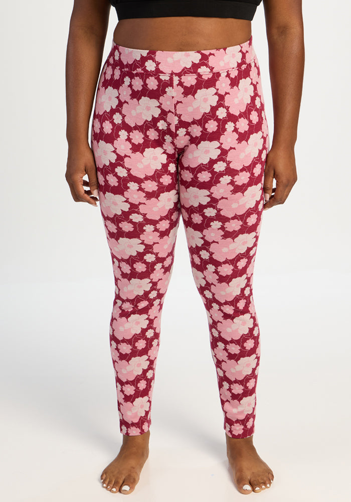 Person wearing Woolx Taylor Baselayer Leggings - Floral Crush, high-waisted Merino wool, barefoot. 