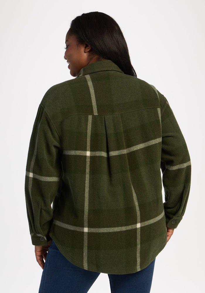 Woman in Woolx Sawyer Shacket - Driftwood Fern Plaid, long-sleeved, with blue jeans, shown from the back on white.