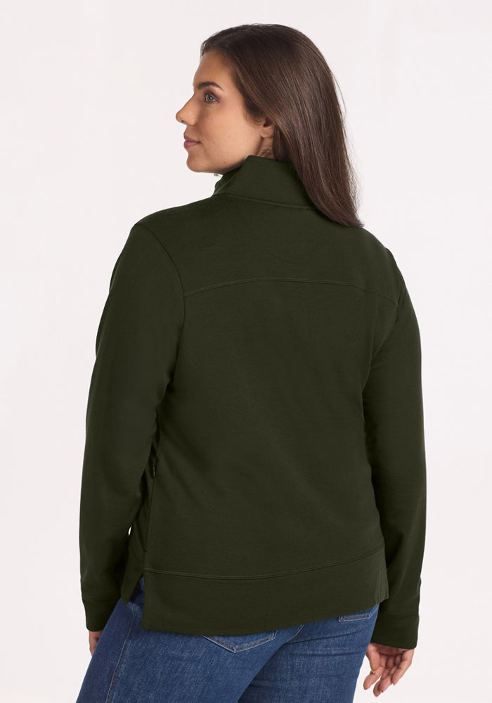 Woman in Woolx Annie 3 Button Pullover - Duffel Bag and jeans looks back at the camera.