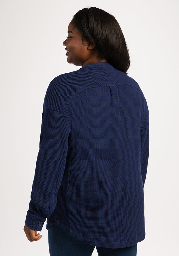 A woman with long dark hair wears the Woolx Oaklynn Waffle Shacket in Ocean Cavern, seen from the back.
