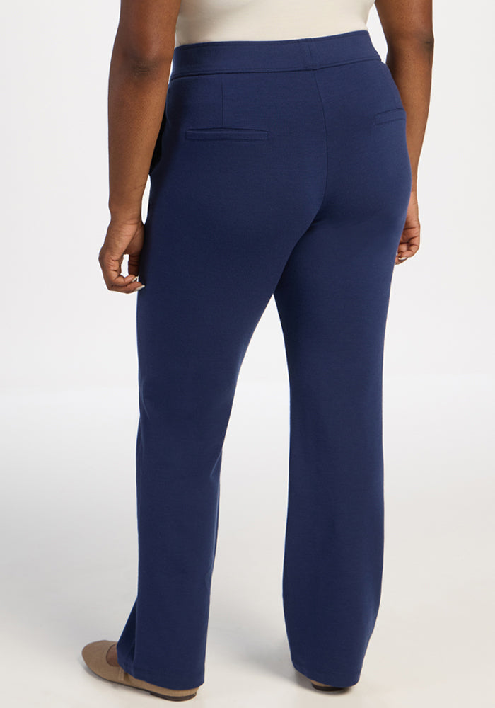 Person in Woolx Emerson Straight Leg Pants - Ocean Cavern and beige shoes, back view on white background.
