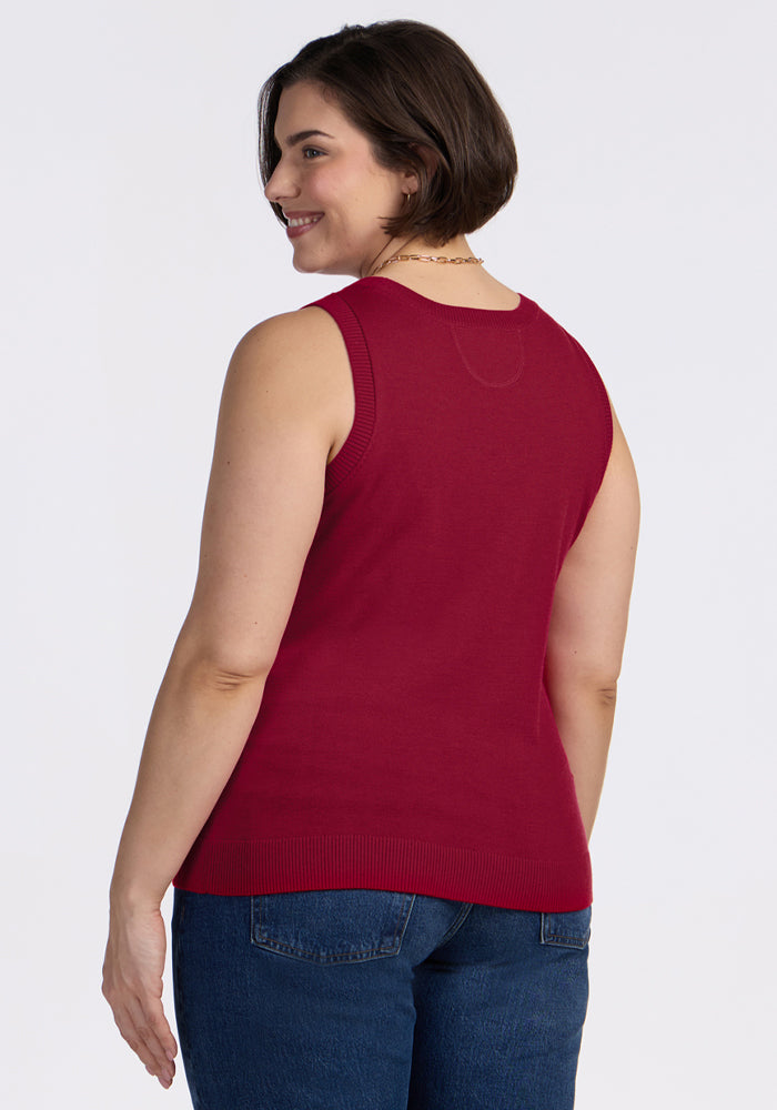 Woman with short brown hair in a Woolx Chessy Tank Top - Beet Red and blue jeans smiles, facing away.