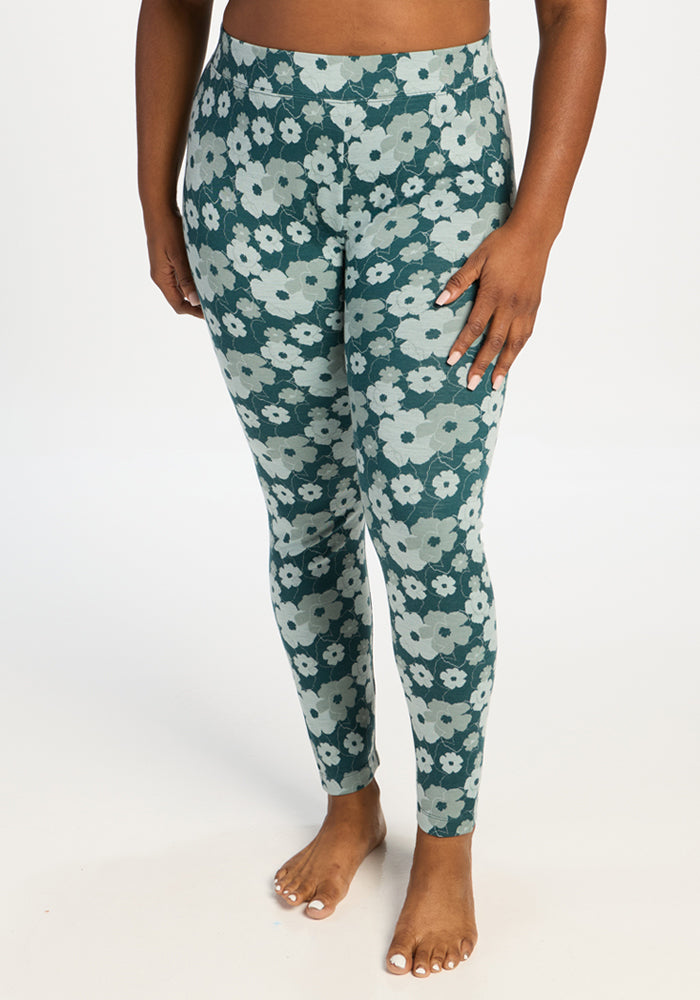 Model in Woolx Taylor Baselayer Leggings - Coastal Wildflower, barefoot against a plain white background. 