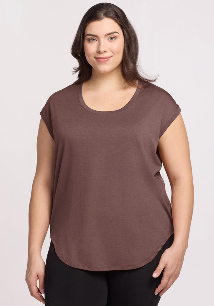 Woman with long brown hair wears the Woolx Gabi Tunic Top in Peppercorn and black pants against a light background. 