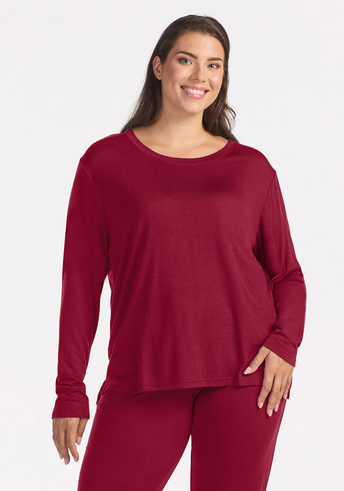 Woman wearing a wrinkle-resistant, beet red Ashlie Lounge Top in crewneck Merino wool. 