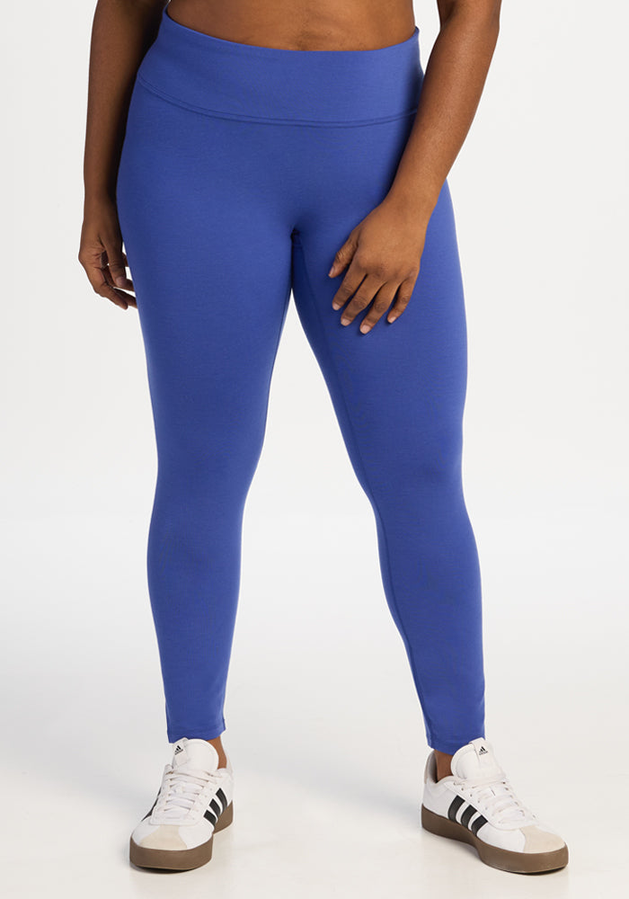 Person wearing comfortable Woolx Angela Leggings - Royal Blue and white sneakers. 