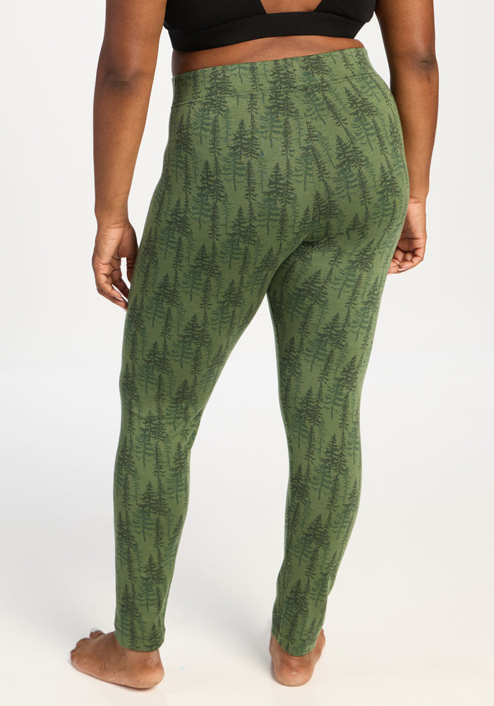 Wearing Woolx Taylor Baselayer Leggings - Forest Friends, they stand barefoot, facing away from the camera.