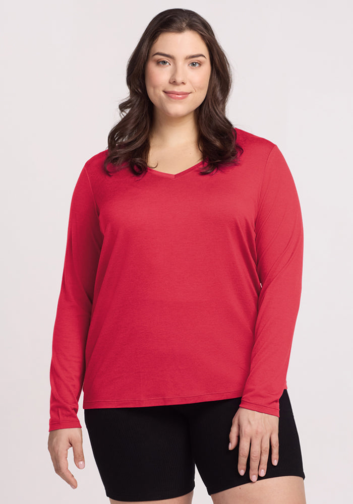 Woman with long dark hair wears the Woolx Millie Long Sleeve - Berry Ice Pop and black shorts, against a light background. 