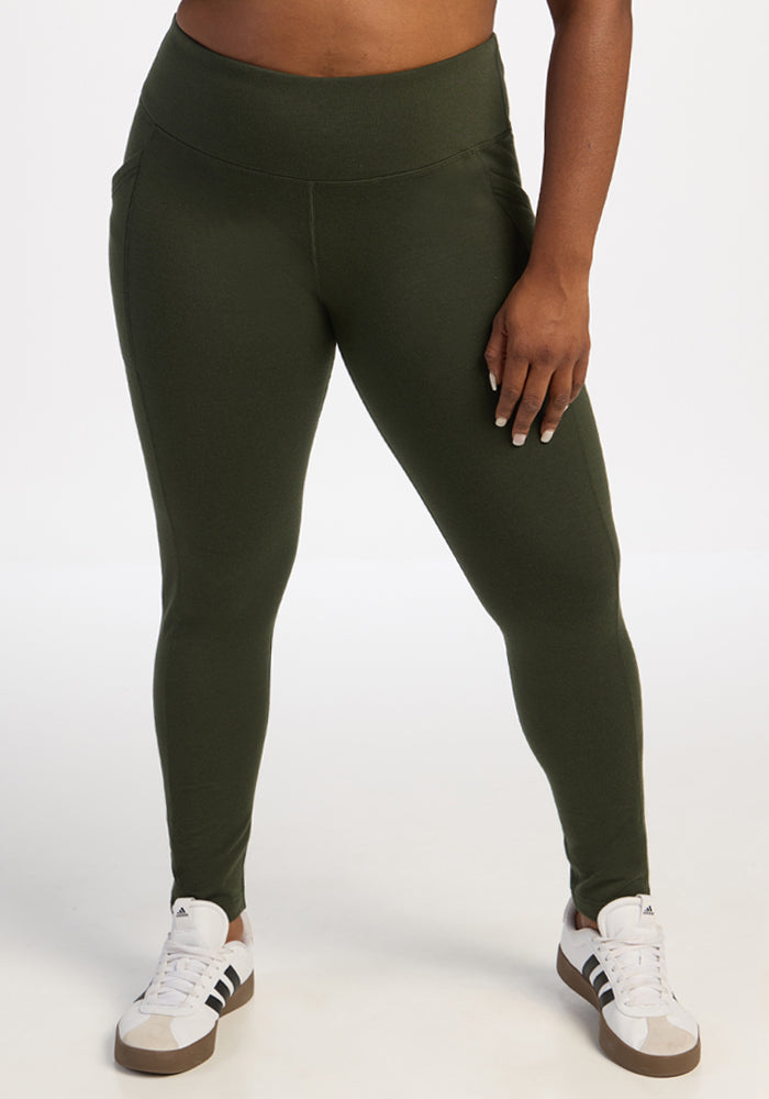 Model in Woolx Frost Leggings - Duffel Bag and white sneakers stands against a plain white background. 