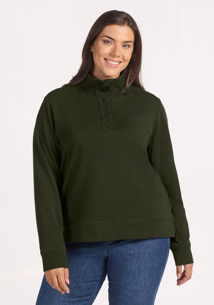 Woman smiling in Woolx Annie 3 Button Pullover - Duffel Bag, paired with blue jeans, against a light background. 